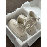 Martin Boots Women’s Thick Sole Lace-up Booties in Beige, displayed in packaging on white tissue paper.
