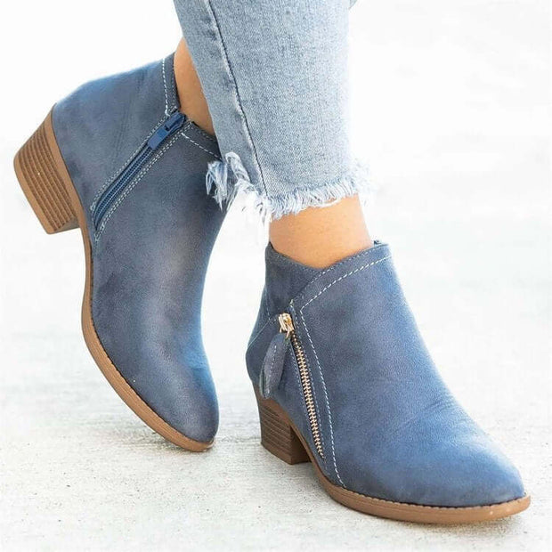 Stylish blue suede ankle boots with a wedge heel, ideal for women's fashion, featuring a zipper and modern design.