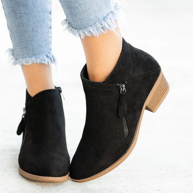 Stylish women's suede ankle boots with wedge heel, perfect for fashion-forward looks and comfort.