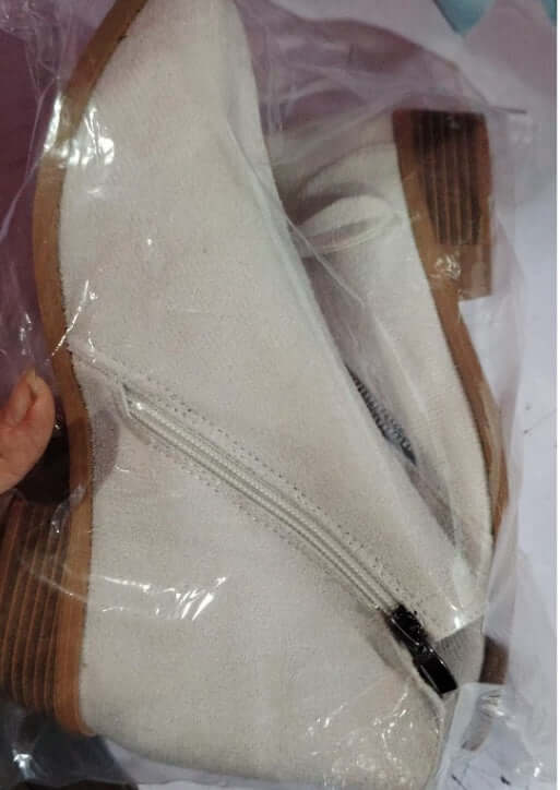 White suede ankle boots with wedge heel and zipper detail, perfect for stylish and warm footwear.