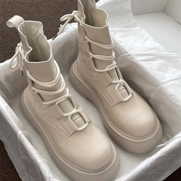 Stylish women's beige Martin boots with thick soles, designed for comfort and durability, featuring front lace-up closure.